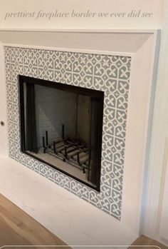 a fireplace with a white and blue tile design on it