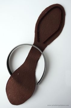 a pair of scissors that are sitting on top of a white table with brown felt