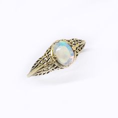 This is a solid 14k yellow gold ring with a beautiful natural crystal opal prong set in a Victorian ring setting. The oval opal cabochon is 6 x 4mm and has bright flashes of green, blue and orange fire. The type of opal is a solid Australian opal that is named crystal opal because of its crystal like transparency. The ring setting is a reproduction of a Victorian ring that has fine filigree details. Custom made to order. Please message me if you would like to choose the opal or a different gemst Classic Ethiopian Opal Gemstone Rings, Gold Ethiopian Opal Heirloom Rings, Classic Cabochon Opal Ring, Gold Ethiopian Opal Ring Hallmarked, Heirloom Ethiopian Opal Gold Rings, Antique Opal Jewelry In Yellow Gold, Gold Opal Ring With Oval Cabochon, Gold Opal Ring With Oval Cabochon Birthstone, Yellow Gold Ring With Ethiopian Opal And Birthstone