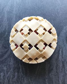 an apple pie with latticed edges on a black countertop, viewed from above