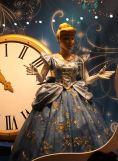 there is a clock in the shape of a princess with her hands on her hips