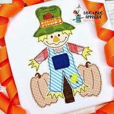 this is an image of a scarecrow applique with pumpkins and leaves