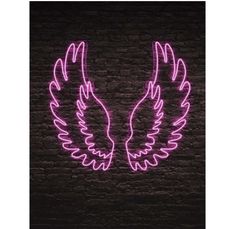 two neon wings on a brick wall