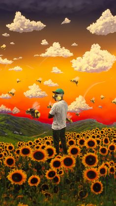 a man standing in the middle of a field of sunflowers under a colorful sky