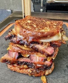 two sandwiches stacked on top of each other in front of an open grilling oven