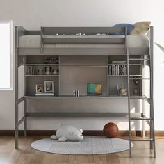 there is a bunk bed with a desk underneath it and a basketball on the floor