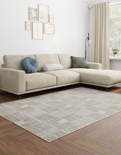 a living room with a sectional couch and rug