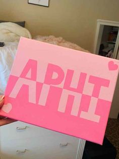 a person holding up a pink sign that says,'apult attie '