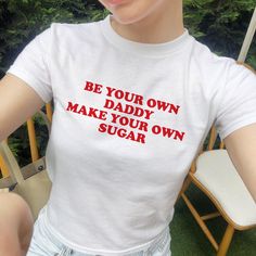 Be Your Own Daddy Make Your Own Sugar Baby Tee, Women's Fitted Tee, Unisex Shirt, Funny Baby Tee, Y2K 90s Baby Tee, Gift for her DETAILS - 100% cotton (fiber content may vary for different colors) - tear-away label  SIZING Sizes vary by shirt style. Please check the size chart before making your purchase. PLEASE NOTE: Our Baby tee is sized for a youth, reminiscent of the '90s-era shrunken-down T-shirt. This style, popularized by the skater/raver culture of the time, is not to be confused with th Retro Cotton Tops With Name Print, Unisex White Tops With Funny Text, Retro Crew Neck Tops With Name Print, Funny White T-shirt For Gender Reveal, 90s Slogan T-shirt In Pink, Bebe Shirt 2000s, 90s Baby Shirt, 90s Style Cotton T-shirt With Funny Text, Funny Baby Tees