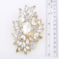 "Gorgeous large rhinestone brooch in gold tone setting, which can be used for your DIY project - wedding, cake and frame decoration, dress sash decor, crafts, scrap booking, jewelry gift and much more. Size: 4 1/4\"H x 2 1/2\"W Stones color: clear Metal: Gold plated This chunky crystal brooch can be ordered with pin in the back to wire into brooch bouquet, add to gown or dress sash, or any number of other craft projects or without the pin as a flat back embellishment for your sew-on, glue-on DIY Brooch Dress, Frame Decoration, Dress Sash, Gold Brooch, Brooch Bouquet, Brooch Bouquets, Dress Pin, Gold Brooches, Crystal Brooch