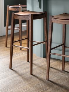 two wooden stools sitting next to each other