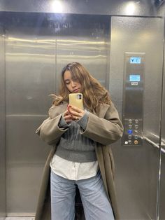 a woman taking a selfie in an elevator