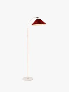 a floor lamp with a red shade on the top and white base, against a white background