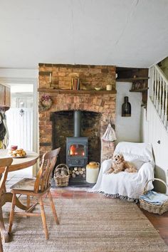 a dog is sitting on a chair in front of the fire place at the living room table