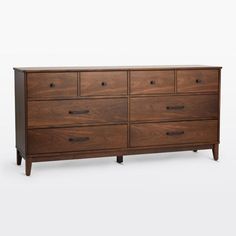 a large wooden dresser with six drawers and two pulls on the bottom, in front of a white background