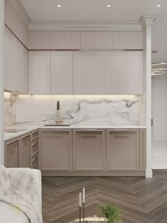 a large kitchen with white cabinets and marble counter tops, along with herringbone flooring