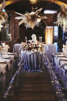 an elegant table setting with candles and flowers