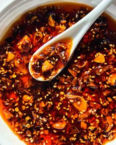 a spoon in a bowl filled with food