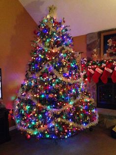 a brightly lit christmas tree in a living room