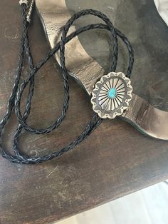 This awesome bolo tie has a southwestern design and agate centerpiece.  The cord is genuine leather. Our bolos pair nicely with many of our belt buckles! They make wonderful gifts.    The western bolo tie rope length is 39'' ; charm agate stone pendant size is 2'' x 1 1/2'' Artisan Turquoise Bolo Ties With Concho, Concho Lariat Bolo Ties For Rodeo, Adjustable Turquoise Bolo Tie For Rodeo, Southwestern Lariat Bolo Ties For Ranch, Adjustable Turquoise Bolo Ties For Rodeo, Bohemian Lariat Bolo Tie For Rodeo, Handmade Lariat Bolo Tie For Western-themed Events, Artisan Bolo Ties With Adjustable Length, Southwestern Bolo Ties With Concho