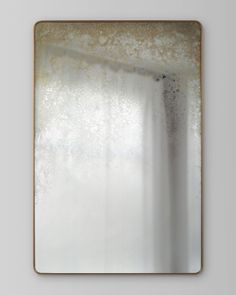 a square mirror hanging on the wall