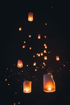 many lanterns floating in the air at night