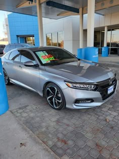 a silver car parked in front of a building