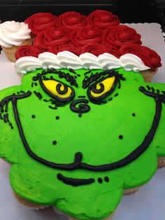 a cupcake decorated to look like the grinch