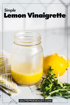 a jar filled with lemon vinaigrete sitting on top of a marble counter