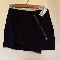 Forever 21. Nwt. Size M. Mini Skirt. Zipper Back. Zipper Detail On Front. Asymmetrical Look. Taupe Leather Detail At Top. Spring Night Out Skort With Asymmetrical Hem, Asymmetrical Hem Skort For Spring Night Out, Asymmetrical Hem Skort For Night Out In Spring, Spring Night Out Asymmetrical Hem Skort, Black Asymmetrical Hem Mini Skirt For Work, Black Fitted Skort With Asymmetrical Hem, Fitted Black Skort With Asymmetrical Hem, Fitted Skort With Asymmetrical Hem For Night Out, Edgy Bottoms With Side Zipper In Mini Length