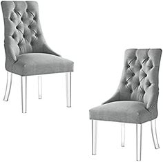 two gray chairs sitting next to each other on top of a white floor and one is upholstered