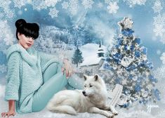 a woman sitting next to a white dog in front of a snow covered christmas tree