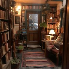 a room filled with lots of books on shelves and a door leading to another room