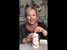 a woman sitting at a table with a jar in front of her and the words share on it