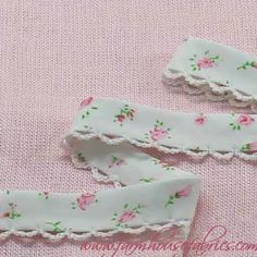 two pieces of white fabric with pink flowers on them