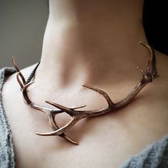 "I have crossed two of my massive elk antlers and cast them into one solid  bronze choker that will surely be the hit of the occasion. The finished piece is a combination of primal elegance and high fashion.  The Antlers are textured on both sides and it is finished with burnished bronze chains and findings.  The Antlers measure 5-3/4\" x 2-1/4\" with an overall end to end length of 18\". MOON RAVEN DESIGNS: Please check out the rest of our shop by clicking: http://www.etsy.com/shop/mrd74?ref=si Elk Antler, Elk Antlers, Fantasy Jewelry, Choker Necklaces, Antlers, Cute Jewelry, Body Jewelry, Elk, Jewelry Inspiration