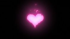 a pink heart shaped object in the dark