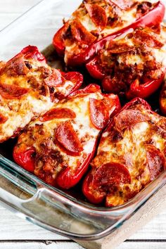 several slices of pepperoni pizza in a glass dish on a white wooden table top