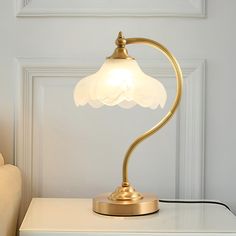 a lamp that is sitting on top of a white table in front of a door