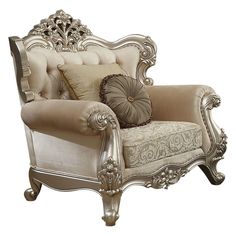 an ornate chair with pillows on the back and arm rests against a white background,