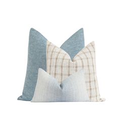 two blue and white pillows sitting on top of each other