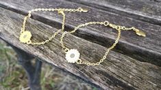 "This bracelet is perfect for anyone! You can choose a yellow sunflower or a white daisy. The metal is a gold color. The flower measures 1/2\" wide. The bracelet has an extender on it so it is adjustable, and it has a heart charm at the end. Perfect for a Mom gift, for a Christmas gift, anniversary, or a birthday. All jewelry items come in a gift box." White Flower Charm Jewelry For Friendship, White Jewelry With Flower Charm For Friendship, Cute White Jewelry For Bridesmaid Gift, Cute Gold Jewelry For Bridesmaids, Cute White Jewelry For Bridesmaids, Gold Bracelet With Birth Flower For Gift, Gold Bracelet With Birth Flower Design, Personalized Gold Flower Bracelets, White Flower Jewelry For Birthday