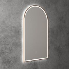 an arch shaped mirror on the wall with light coming in from it's side