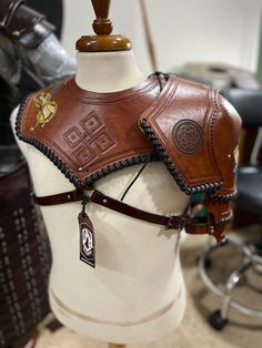 a brown leather horse bridle on top of a white mannequin