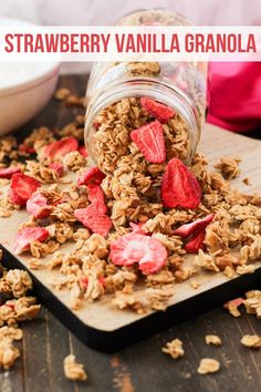 strawberry vanilla granola is being poured into a jar