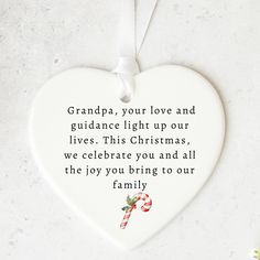 a ceramic heart ornament with the words grandpa, your love and guidance light up our lives this christmas, we celebrate you and all the joy you bring to our family