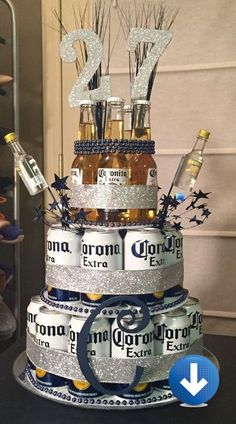 a cake made to look like it is stacked with beer bottles and sparklers on top