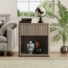 a living room with a couch, chair and vases on the table in front of a window