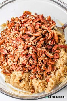 a glass bowl filled with nuts on top of a table