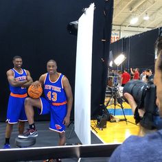 two basketball players standing in front of a camera